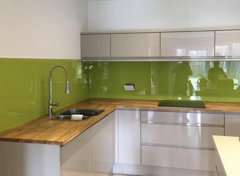 A green and white kitchen with a gorgeous Kitchen Splashback
