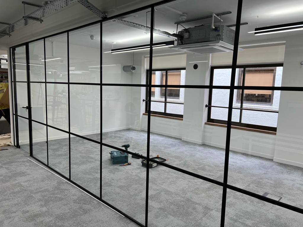 long glass partition wall with glass door at the end