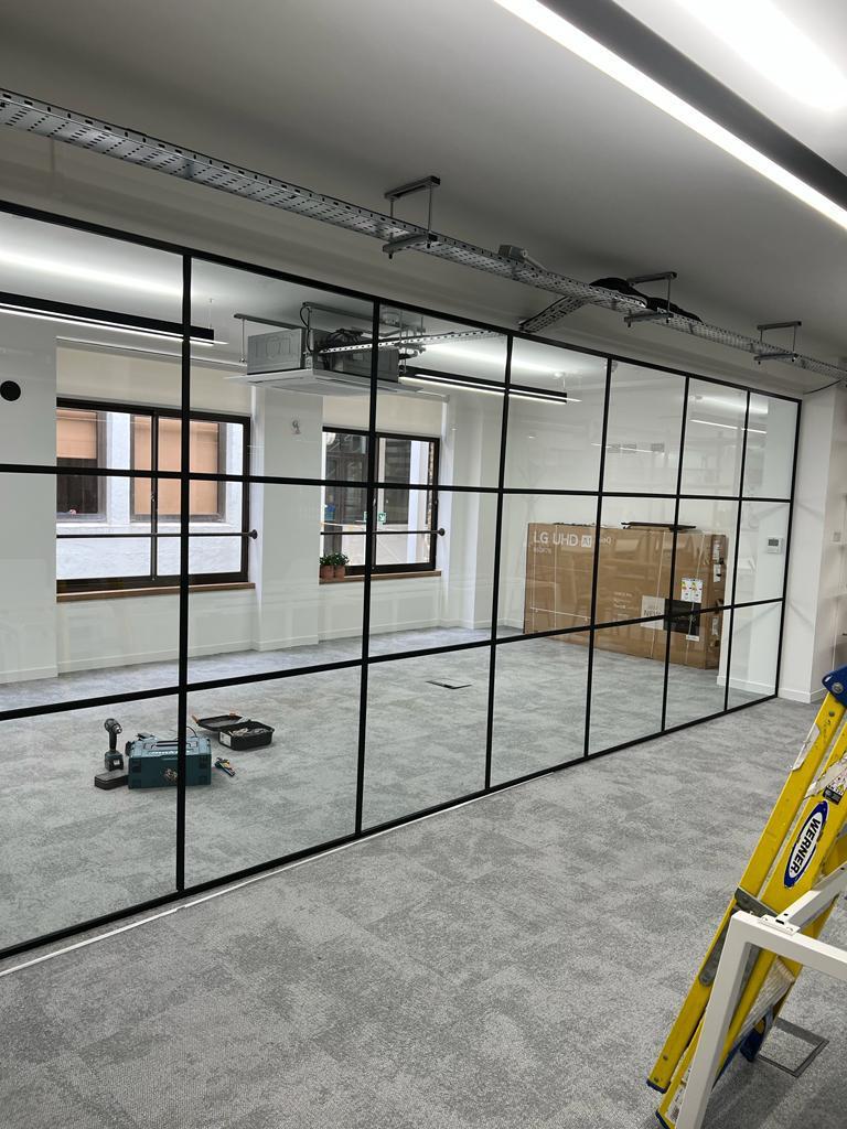 A glass partition in an office ready for work!
